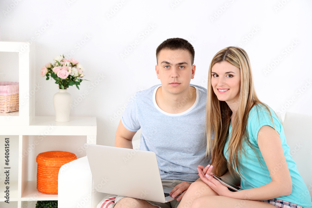 Loving couple sitting with laptop Loving couple sitting with laptop
