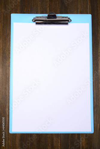 Clipboard on wooden background