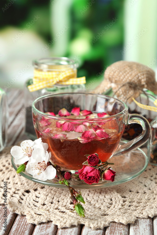 Assortment of herbs, tea in glass jars and hot drink in cup Assortment of herbs, tea in glass jars and hot drink in cup