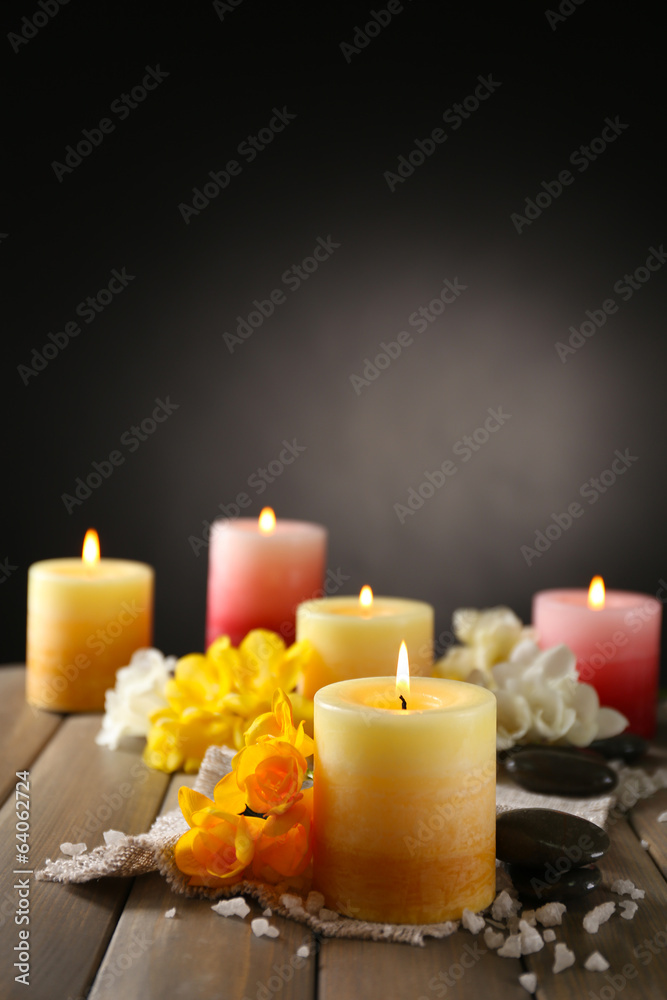 Beautiful candles with flowers on wooden background Beautiful candles with flowers on wooden background