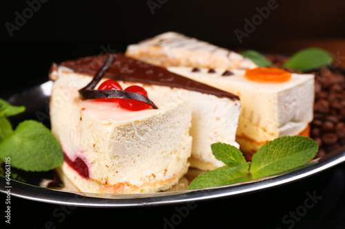 Assortment of pieces of cake, on dark background
