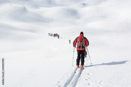 Skiers walking over snowy planes