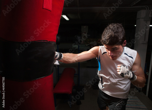 Young caucasian Boxer training with a punching bag © ramonespelt