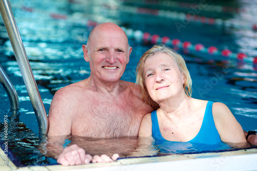 Happy couple of seniors enjoying in swimming pool