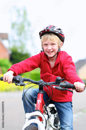Portrait of happy school boy on his bike