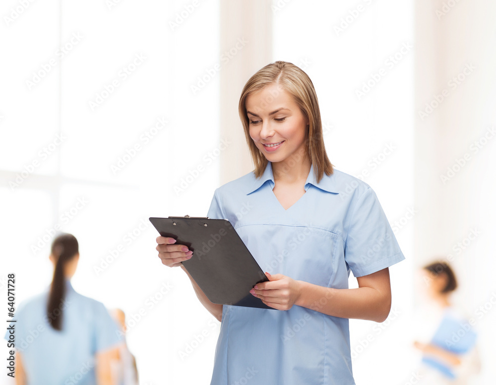 smiling female doctor or nurse with clipboard smiling female doctor or nurse with clipboard