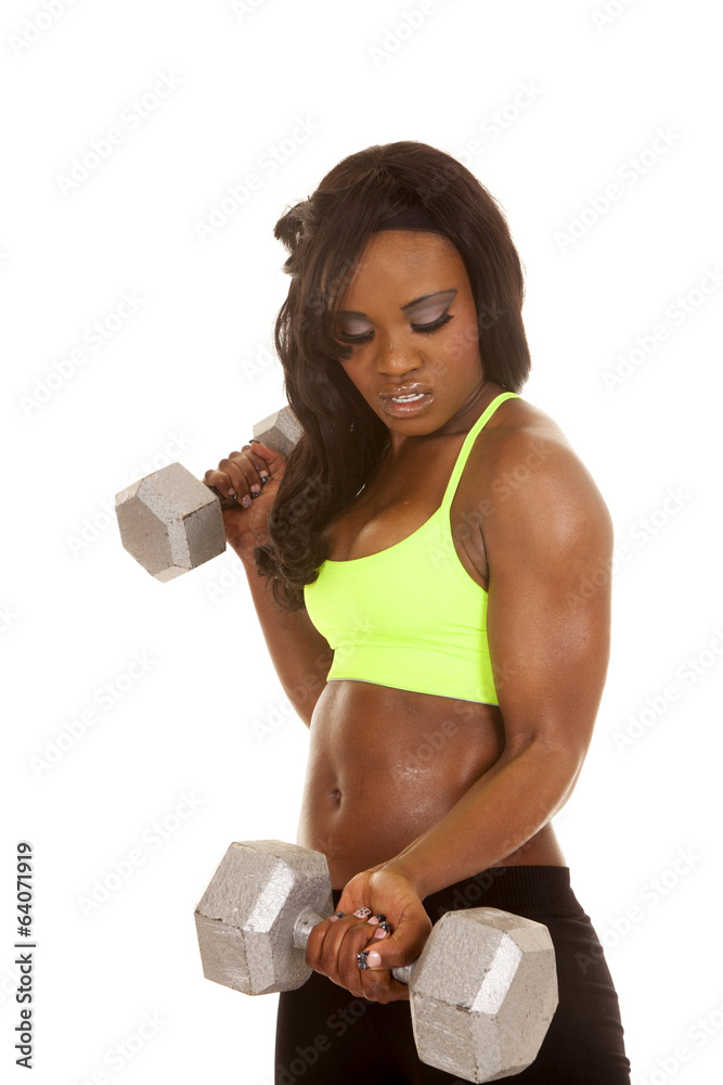 African American woman green bra weights curl look down