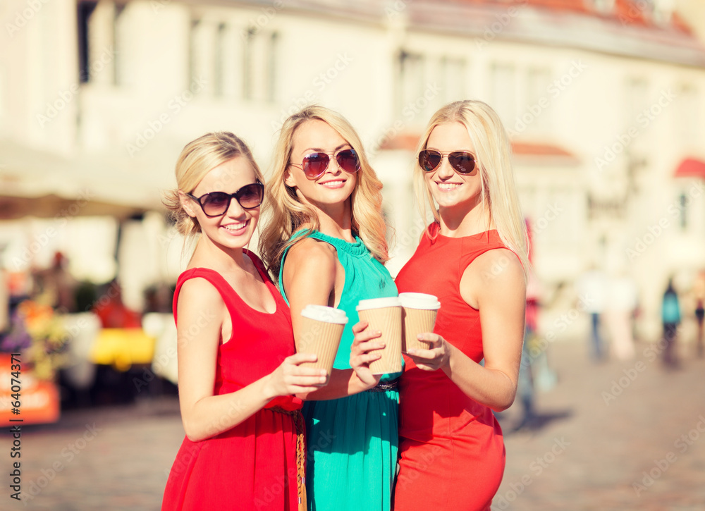 women with takeaway coffee cups in the city women with takeaway coffee cups in the city