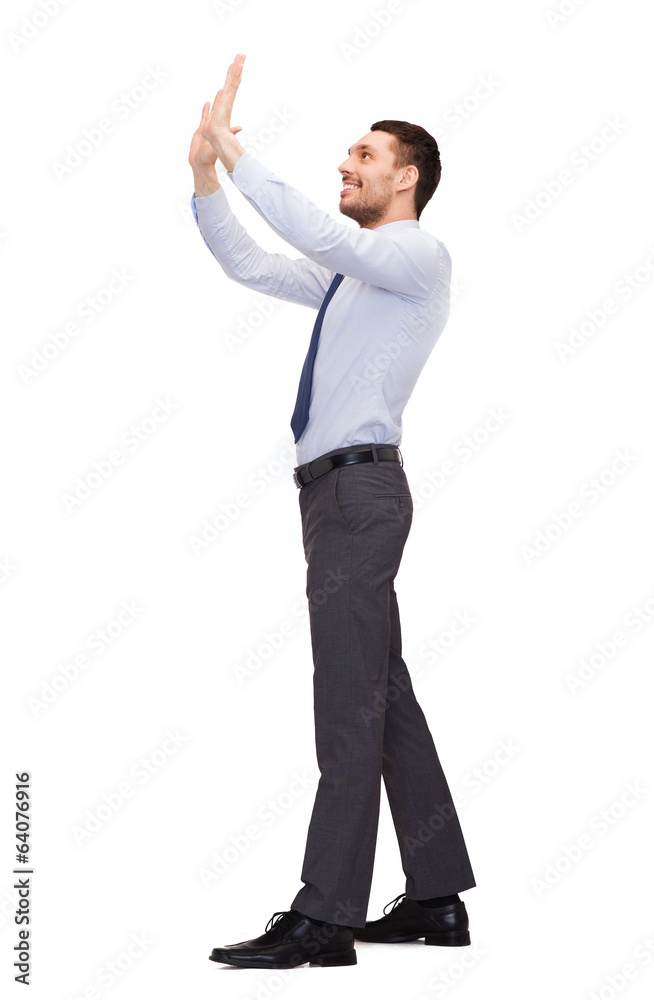 smiling businessman pushing up something imaginary smiling businessman pushing up something imaginary