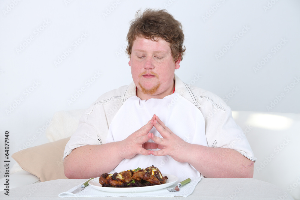 Tasty lunch for fat man, on home interior background Tasty lunch for fat man, on home interior background