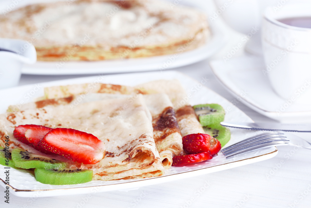 Delicious pancakes with strawberries and chocolate Delicious pancakes with strawberries and chocolate