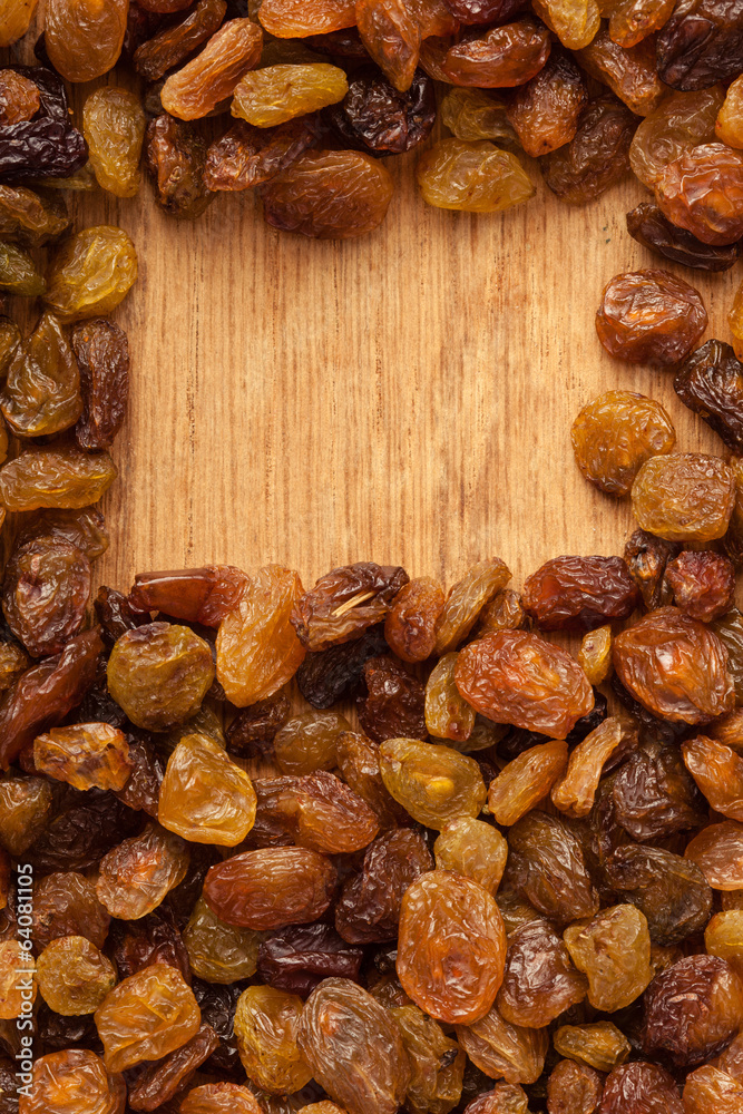 Diet healthy food. Border of raisin on wooden background