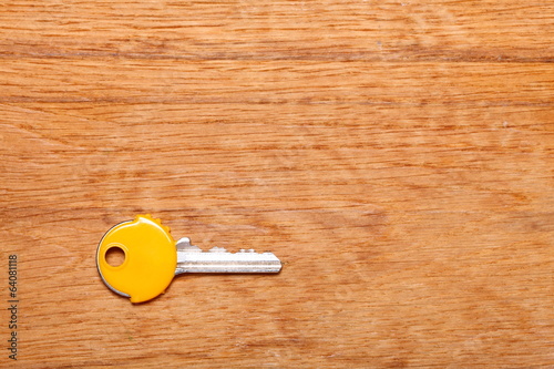 House key with yellow plastic coats caps on table