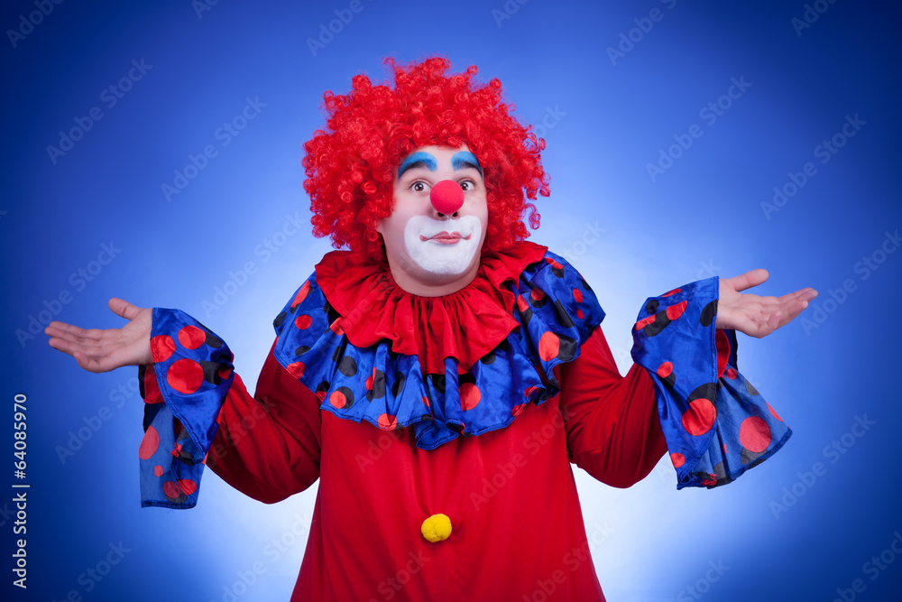 Surprised clown on blue background