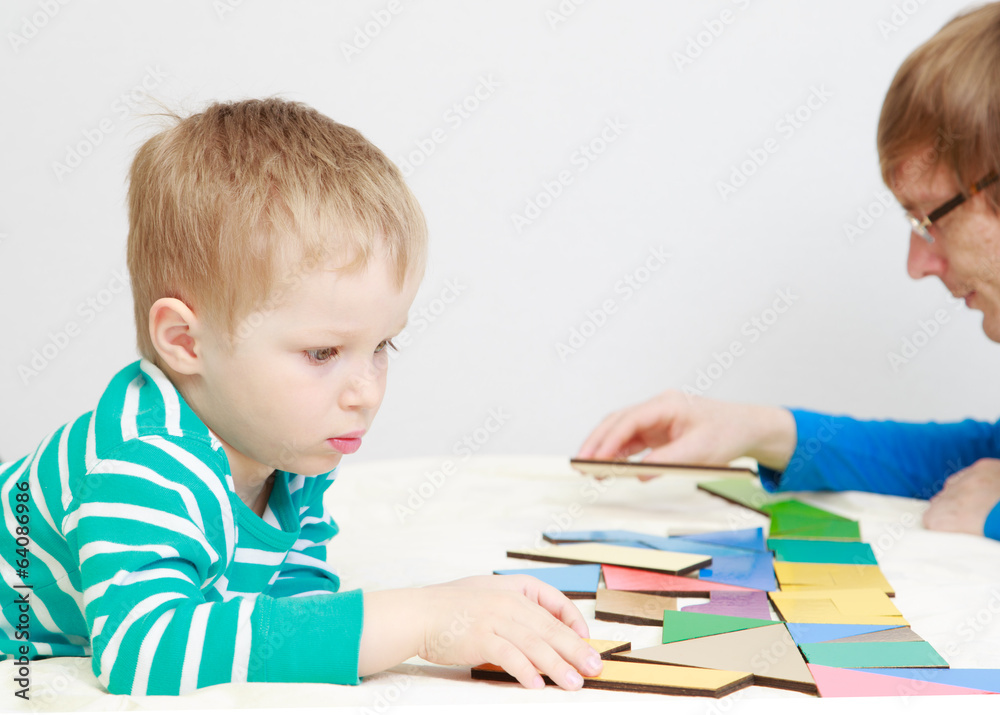 child playing with puzzle, early education concept child playing with puzzle, early education concept