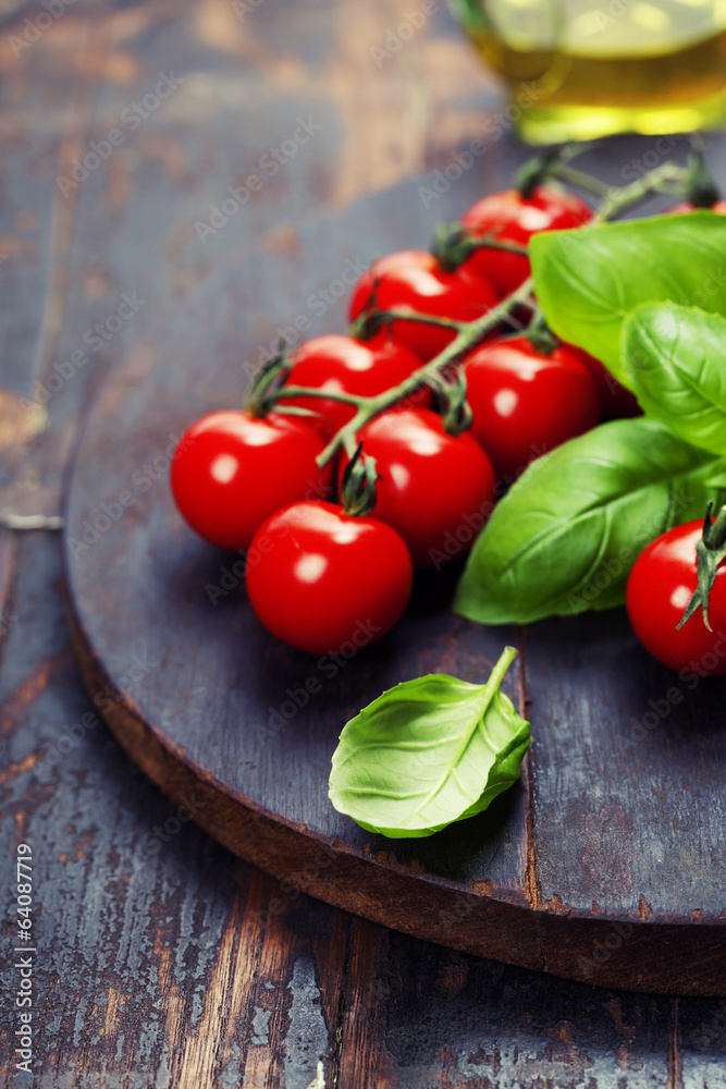 Tomatoes with basil on wooden table background Tomatoes with basil on wooden table background