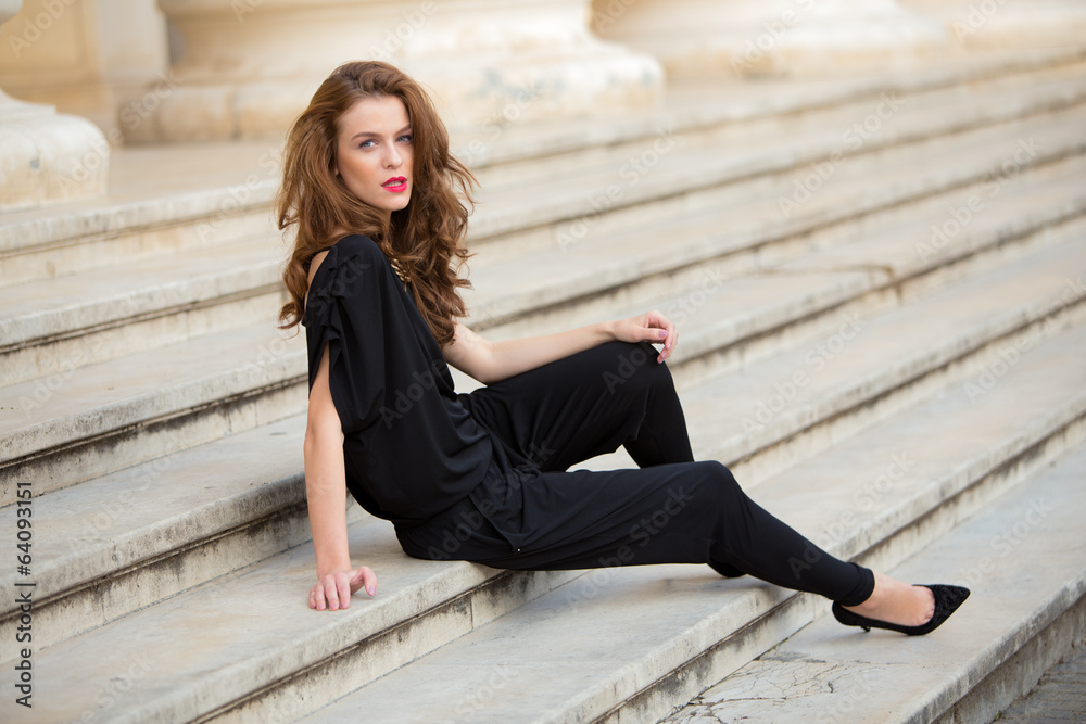 Fashionable woman in backless jumpsuit Fashionable woman in backless jumpsuit