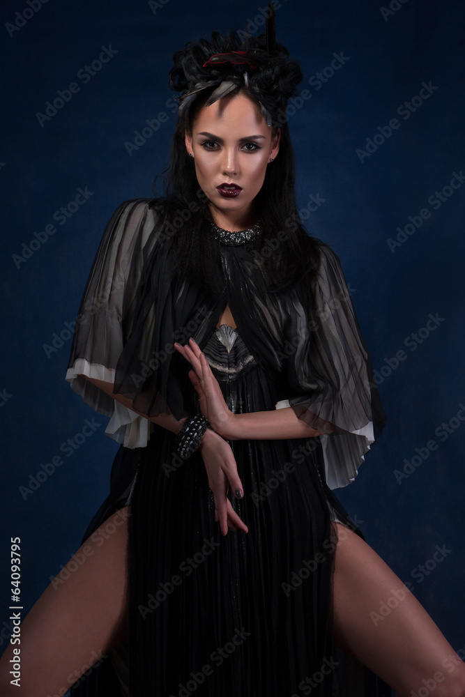 Woman shaman dancing over dark blue background