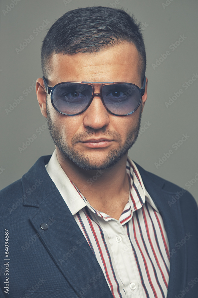 Fierce successful man in violet sunglasses