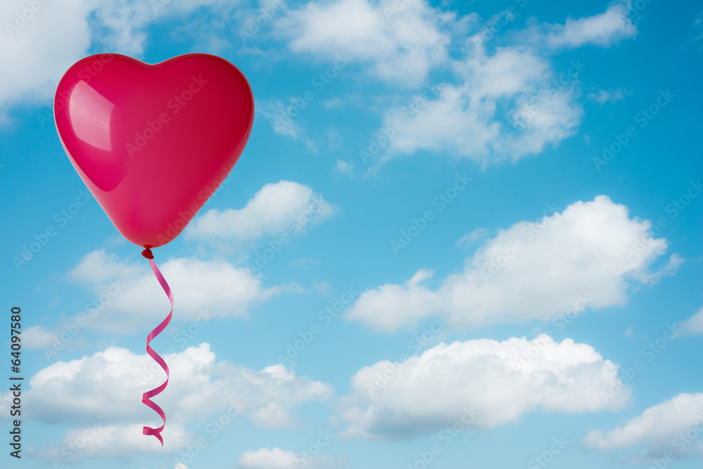 Heart shape balloon on sky background