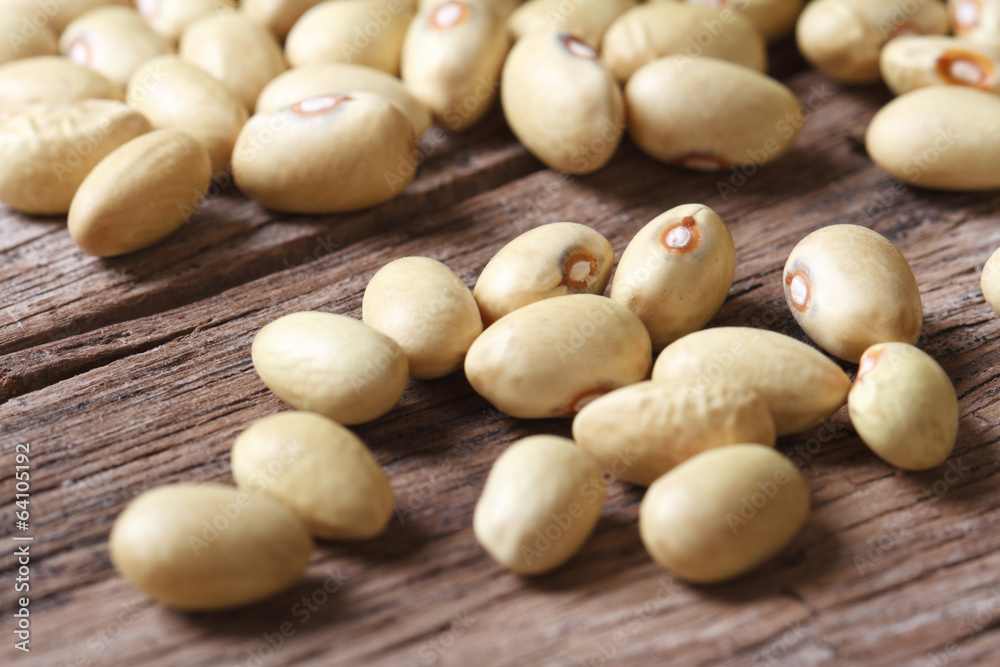 Dry yellow kidney beans sprinkled on the old table