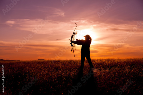 Woman Bowhunter in Sunset