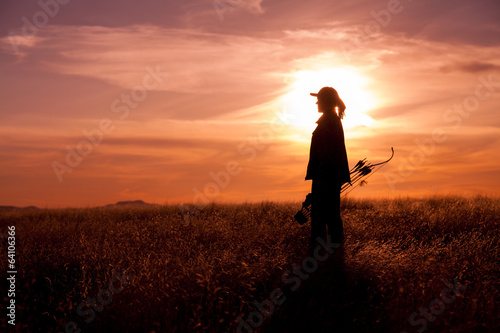 Woman Bowhunter at Sunset photo