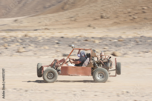 Desert buggy racing across ground