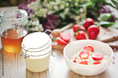 Healthy breakfast with strawberry, cottage cheese, honey and cre