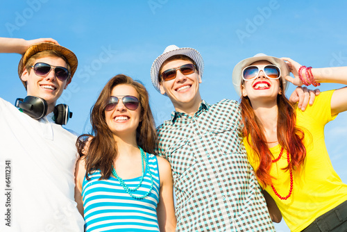 group of young people wearing sunglasses and hat