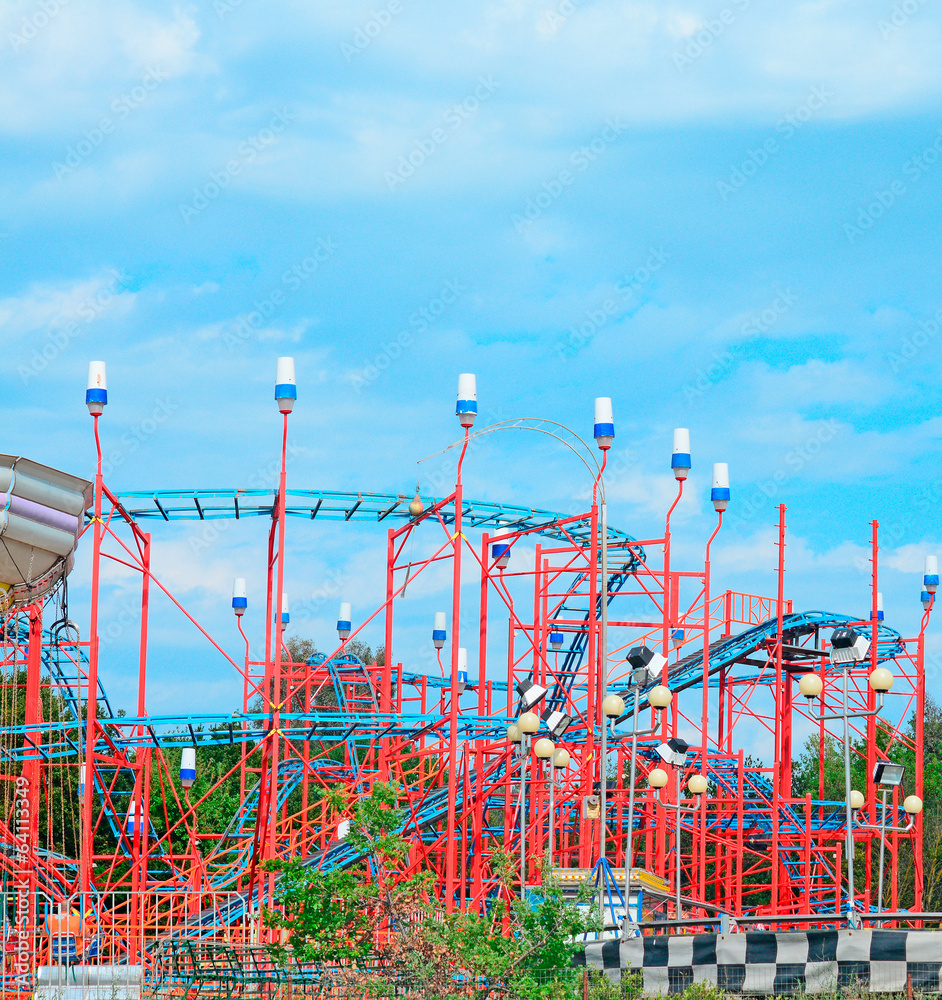 red roller coaster under a blue sky