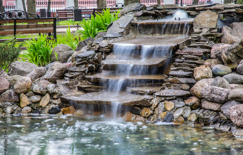 Artificial waterfall in the park photo