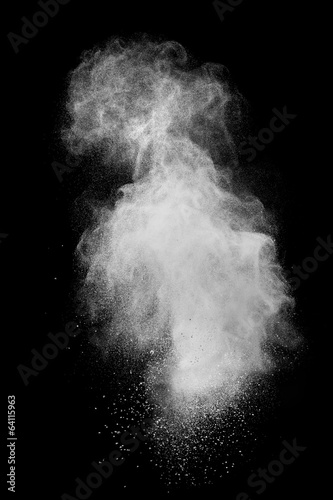 White powder explosion isolated on black