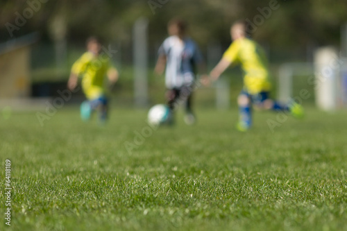 Three kids playing soccer