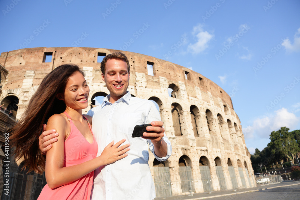 Couple in Rome by Colosseum using smart phone
