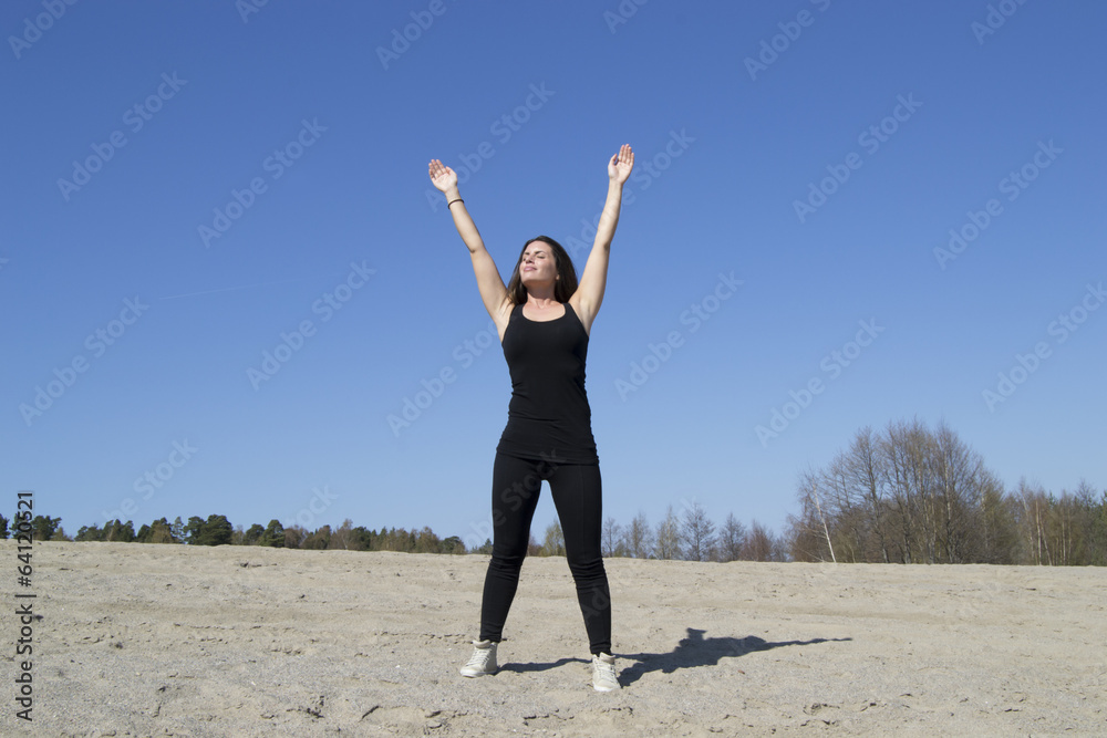 Woman stretching / working out at the beach (sunny day) Woman stretching / working out at the beach (sunny day)