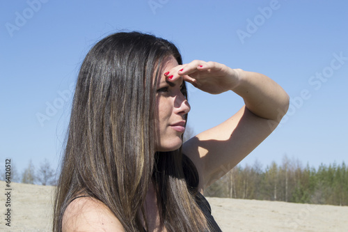 Woman looks around (beach, nature, sunshine)