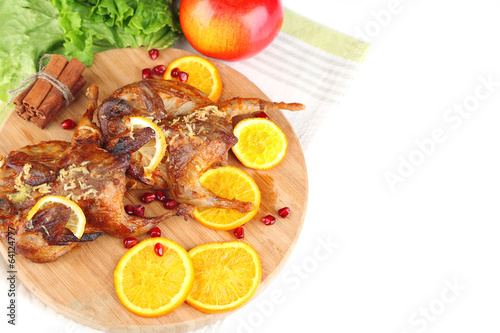 Roasted quails on cutting board, isolated on white