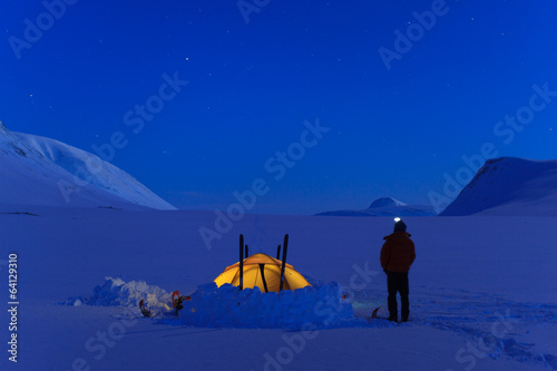 Tent in the snow during a night in Lapland.