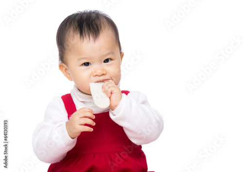 Asian baby girl eating biscuit