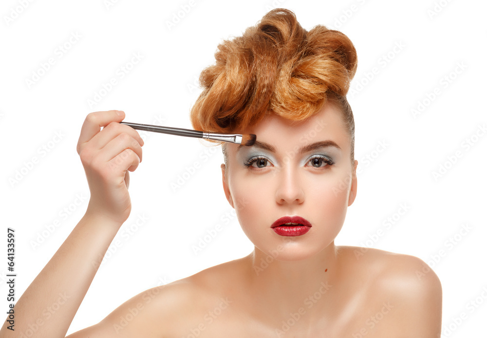 Beauty portrait of pretty woman with brush for makeup