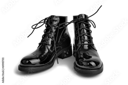 Pair of varnished unisex shoes isolated on white background