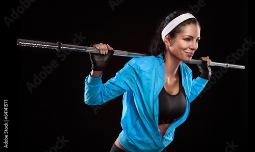Beautiful young woman exercises with barbell dumbbell Isolated o
