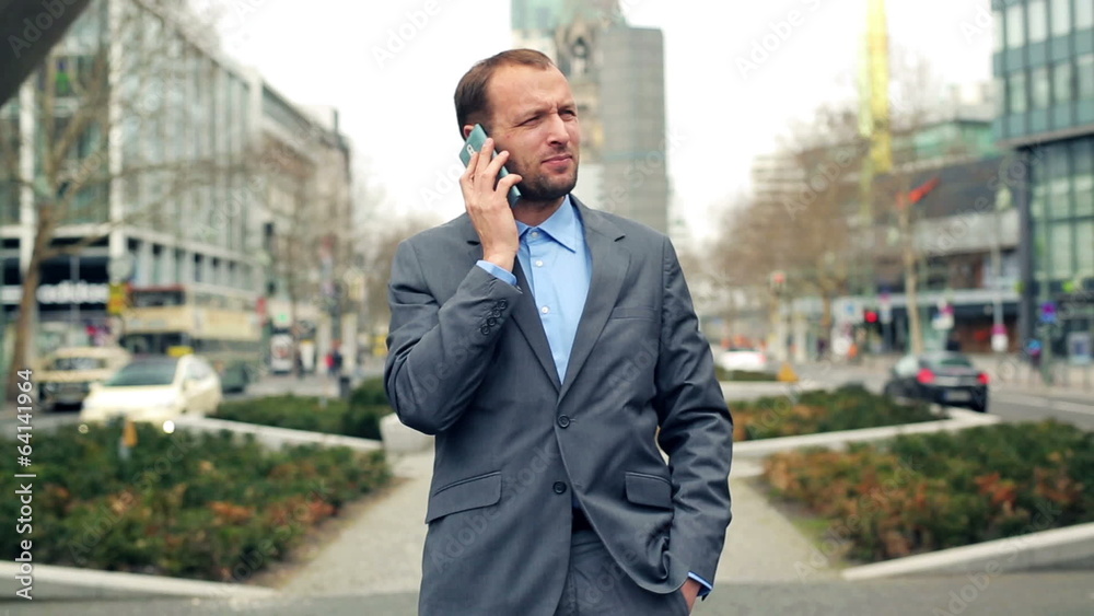 Young businessman talking on cellphone in the city Young businessman talking on cellphone in the city