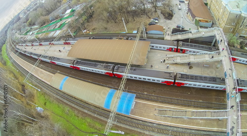 View from unmanned quadrocopter to train on railway platform photo