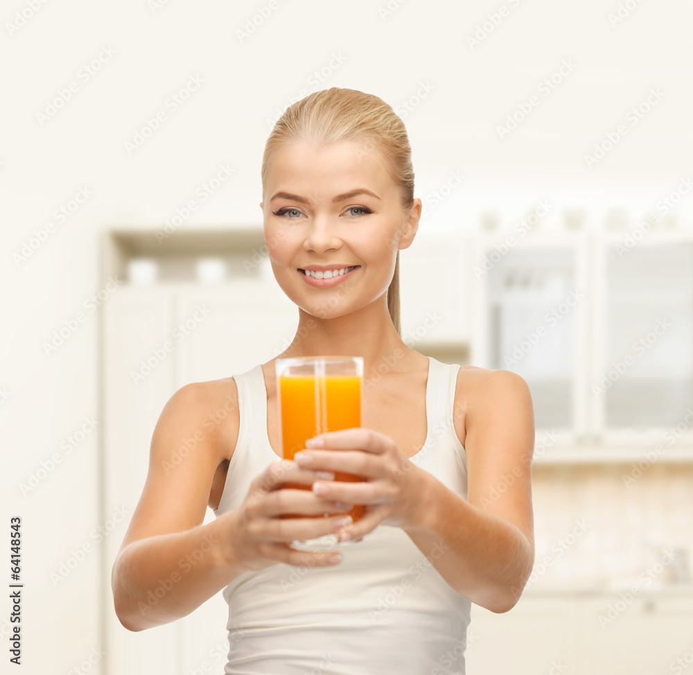 smiling woman holding glass of orange juice smiling woman holding glass of orange juice