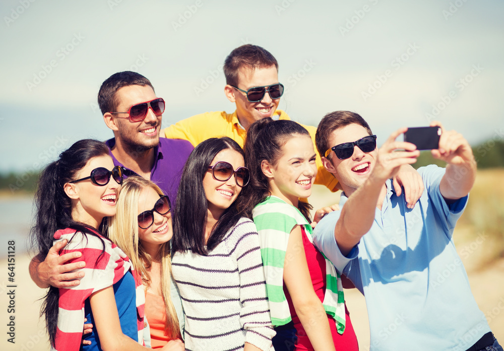 group of friends taking picture with smartphone group of friends taking picture with smartphone