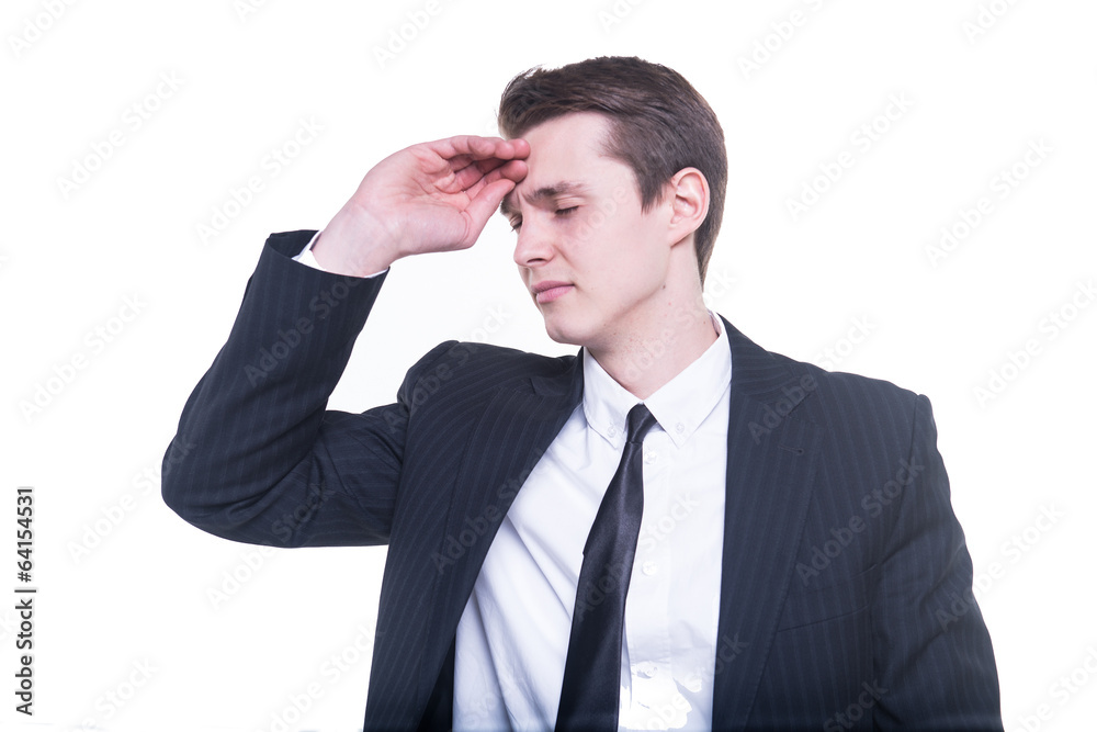Young businessman with a big headache isolated on white