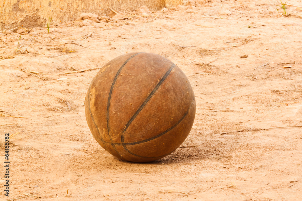 the old basketball on sand