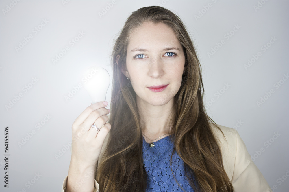 Woman holding lit light bulb Woman holding lit light bulb